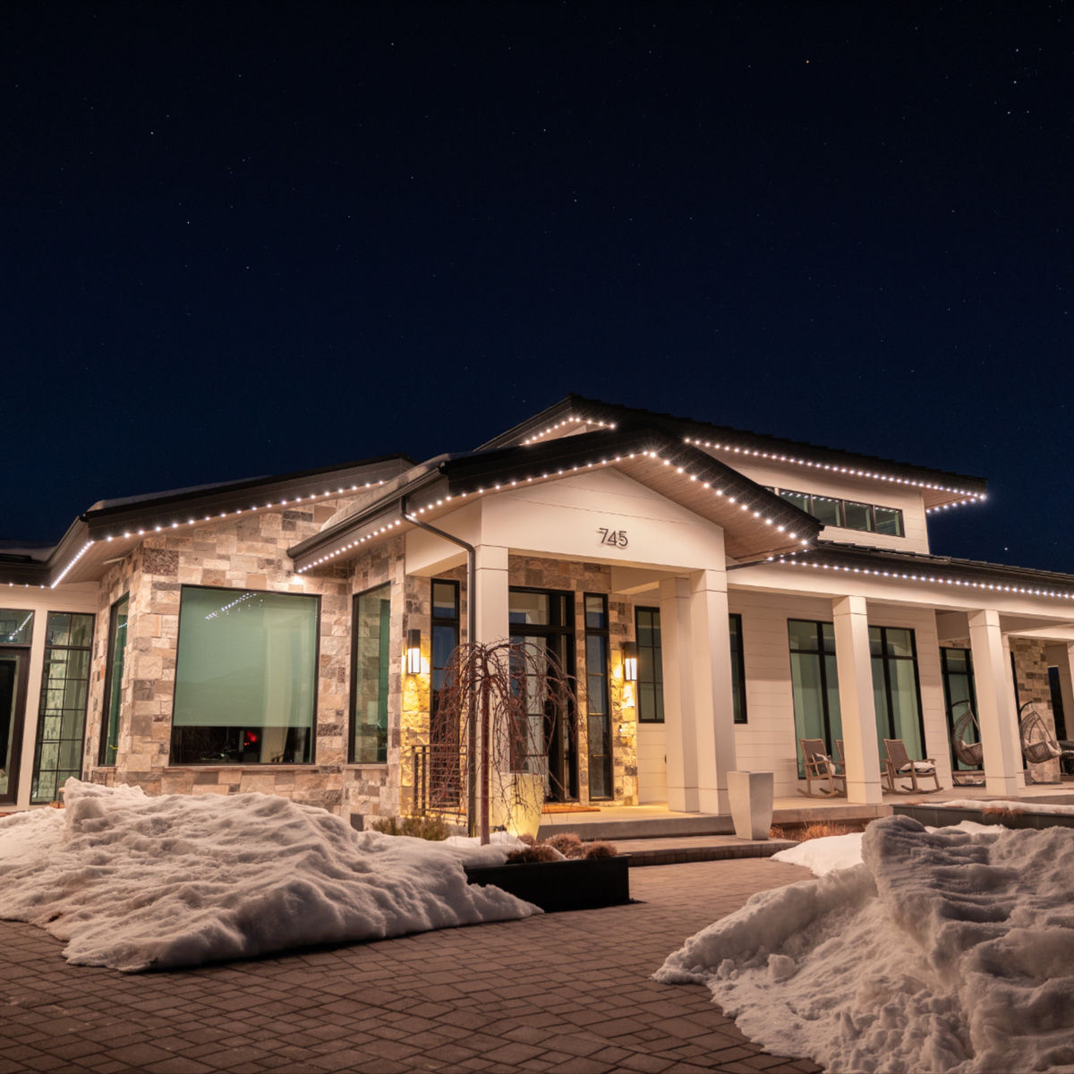 Starise permanent accent lighting along a Calgary house roofline at night